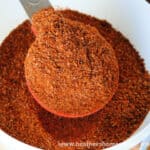 Homemade Taco Seasoning in white bowl with a scooped tablespoon.