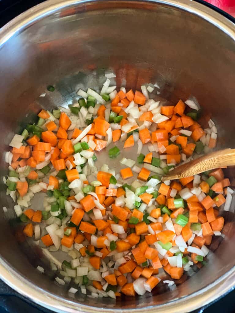 Onions, carrots and celery being sautéed in instant pot.