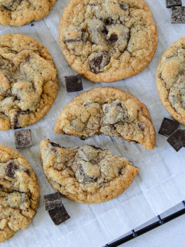 Chocolate chunk cookies with one cookie broken in half.