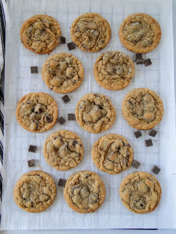 Chocolate chunk cookies in rows on parchment lined cookie sheet.