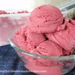 Homemade Red Velvet Ice Cream scoops in clear dish.