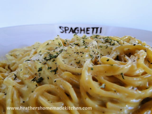 Classic Spaghetti Carbonara close up view with parsley and black pepper on top. 