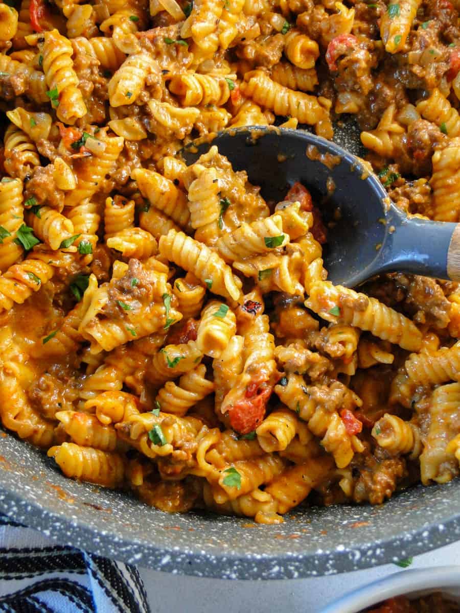 Taco pasta skillet in round skillet with serving spoon.