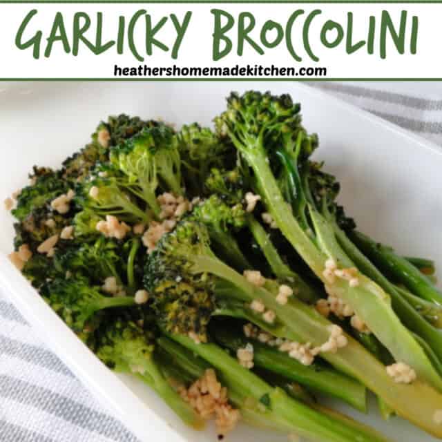 Garlicky Broccolini in white dish with bits of garlic. 