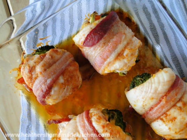 Top view Bacon Wrapped Cheesy Broccoli Chicken in glass baking dish. 