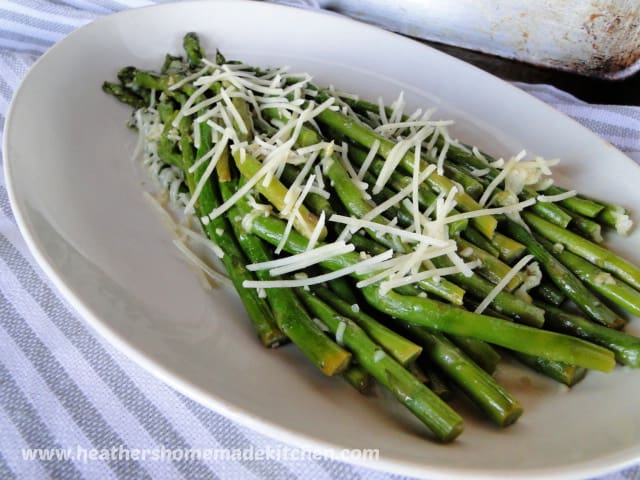 Garlic Parmesan Sauteed Asparagus side view on oval white plate