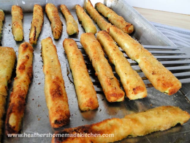Air Fryer Zucchini Fries on sheet pan with a spatula.