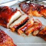 Oven Roasted BBQ Chicken breasts, sliced diagonally on sheet pan.