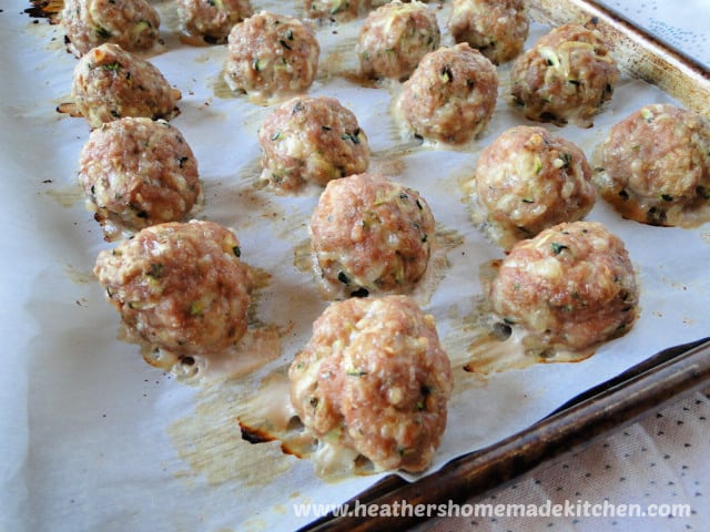 Turkey & Zucchini Meatballs in rows on a sheet pan.