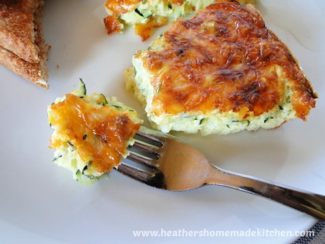 One triangle slice of Zucchini Frittata with a bite on a fork.