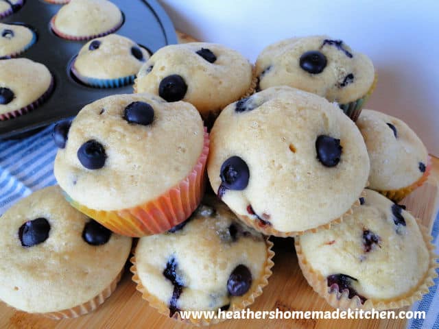 Easy Blueberry Muffins in a pile on board. 