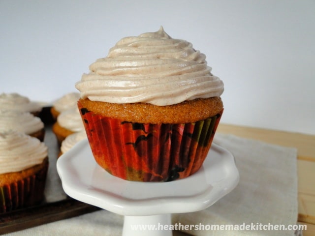 Close up side view of Pumpkin Cupcake on white stand. 