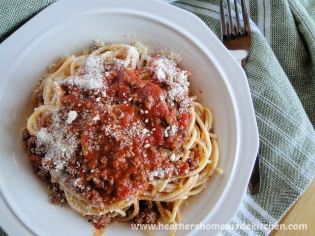 Top view of Simple Spaghetti Meat Sauce over spaghetti pasta in white bowl. 