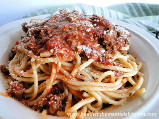 Simple Spaghetti Sauce over spaghetti pasta in white bowl.