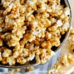 Easy Homemade Caramel Corn Recipe in bowl with scattered caramel corn.
