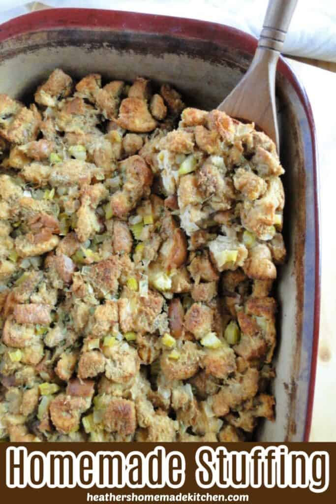Top view of Homemade Stuffing in casserole with scoop on wooden spoon.