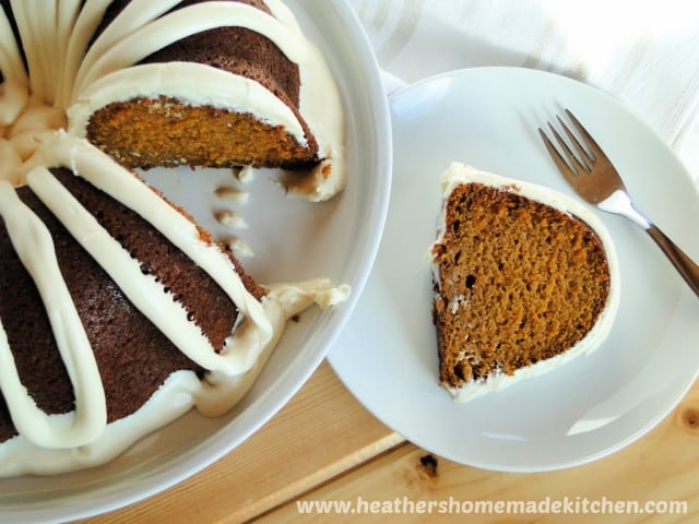 Top view of Pumpkin Pie Bundt Cake with slice on white round plate. 