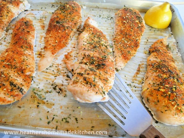 Simple Roasted Chicken Breasts on spatula over sheet pan. 