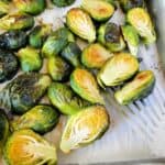 Easy oven roasted brussels sprouts on sheet pan with spatula.