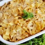 Chicken and noodles in white casserole dish.