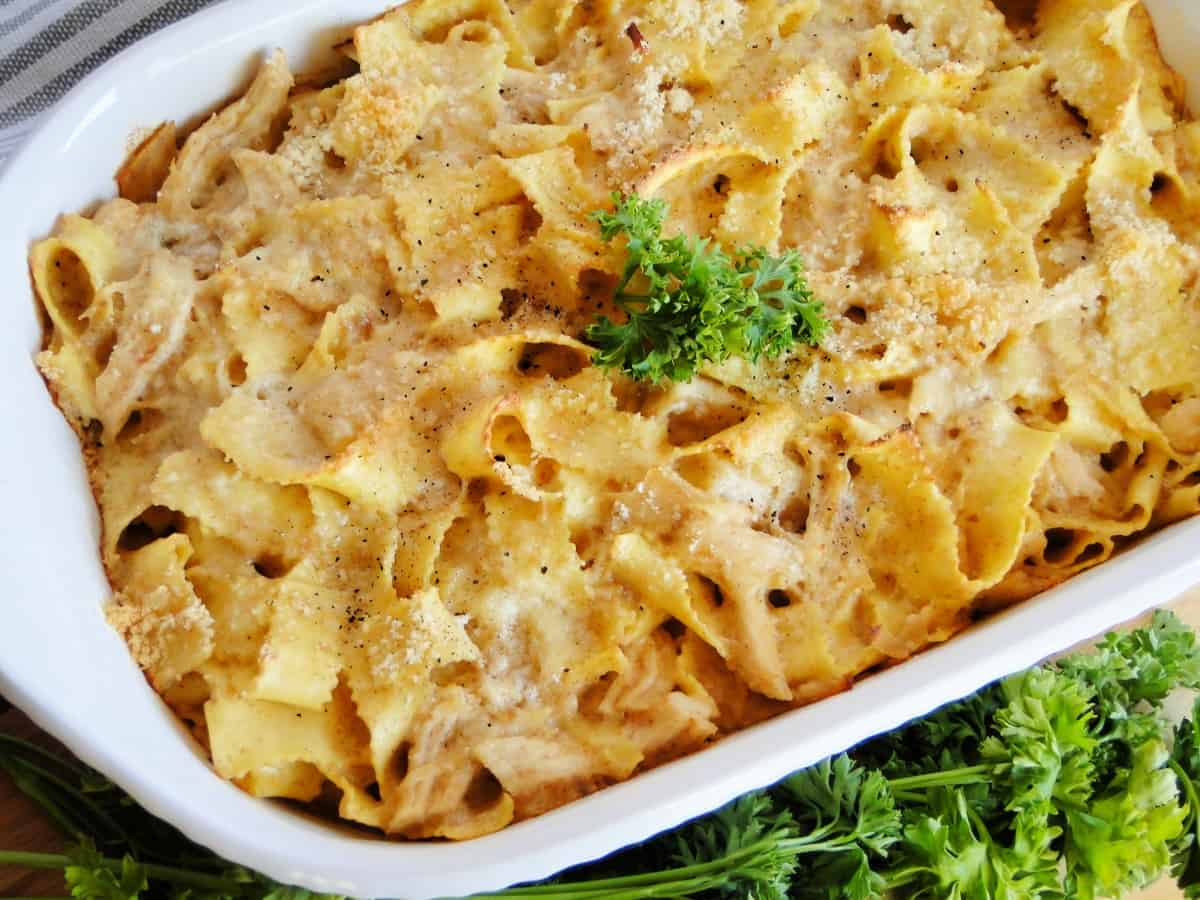 Chicken and noodles in white casserole dish.