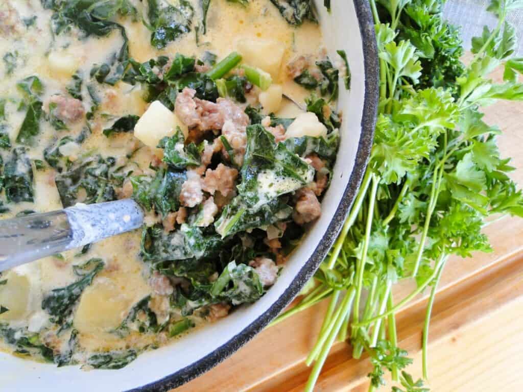 Ladleful of Easy Zuppa Toscana Soup in full pot of soup.  