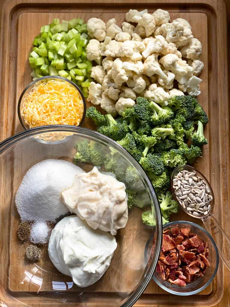 Broccoli and cauliflower salad ingredients on board.