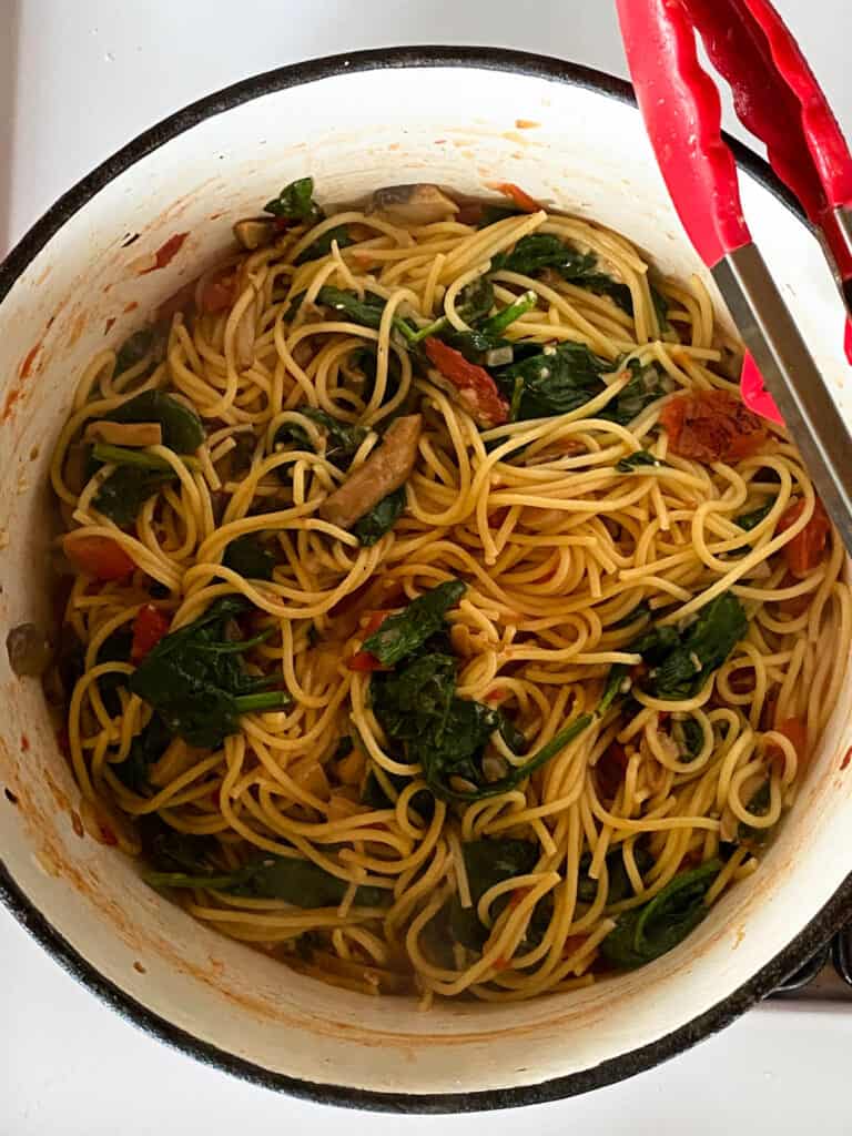 Cooked spaghetti dish in pot.