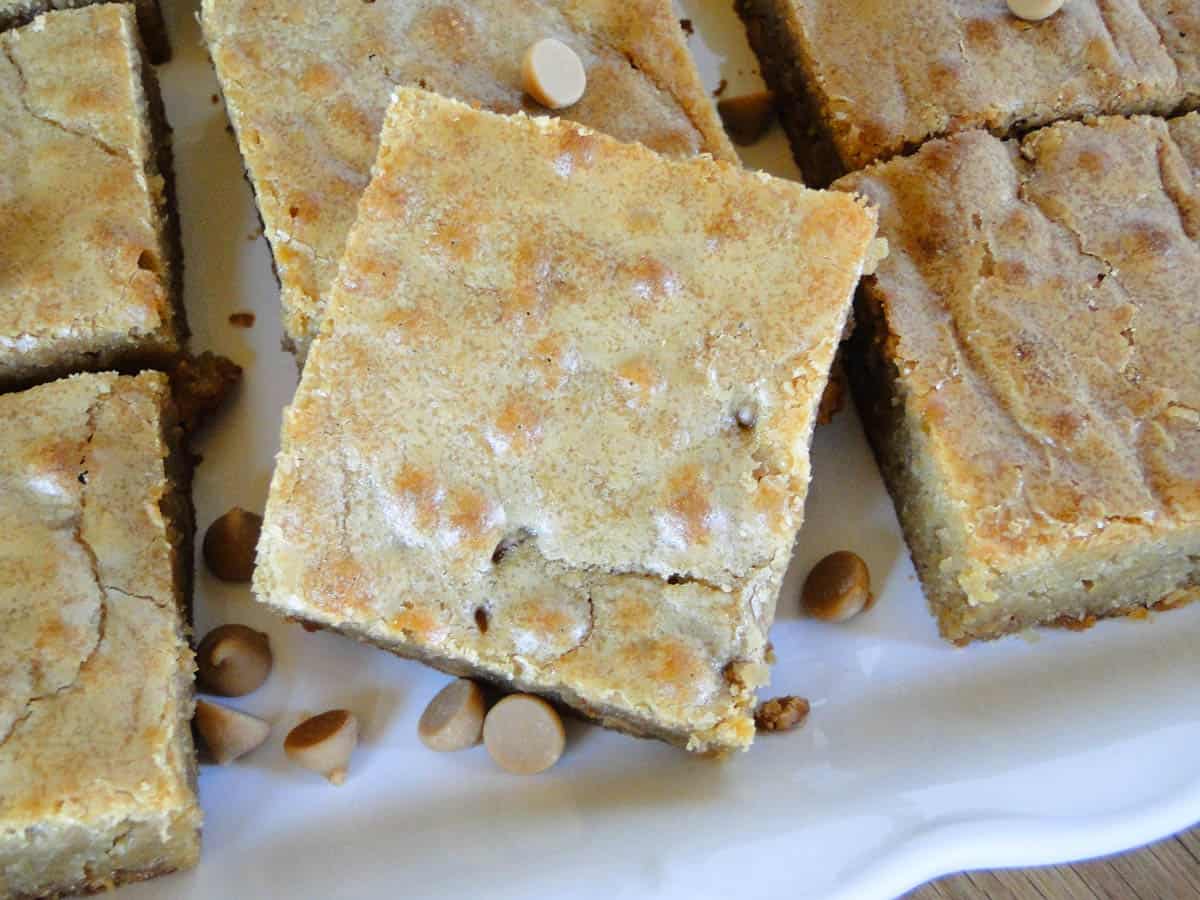 Butterscotch brownies cut into squares showing crackled top.