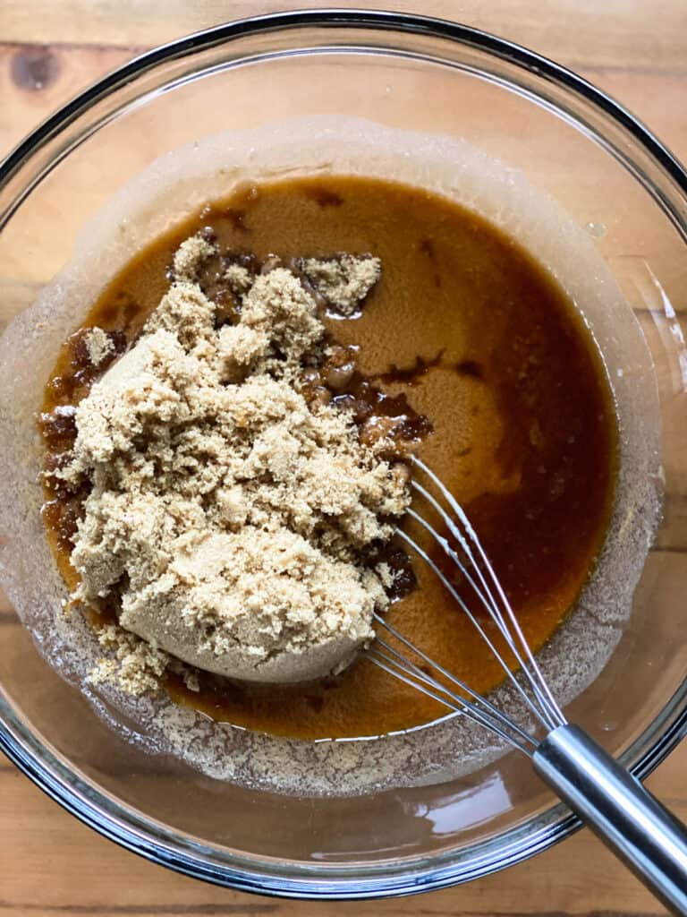 Brown sugar added to melted butterscotch and butter in large glass bowl.