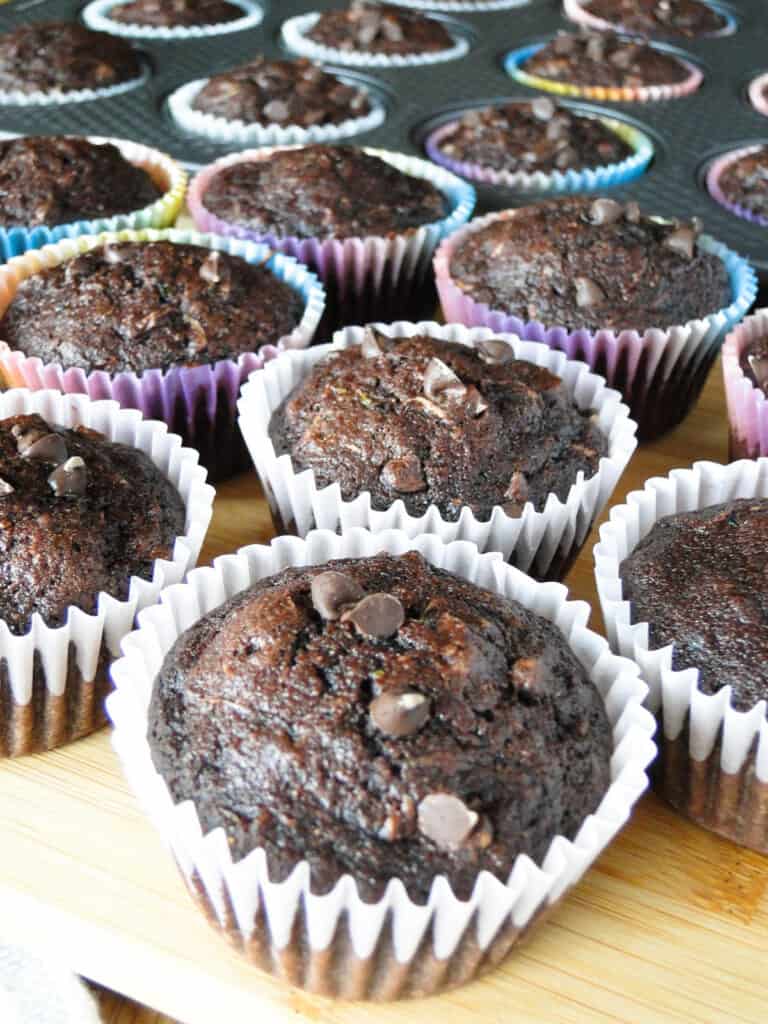 Chocolate Zucchini Muffins served on wooden board.