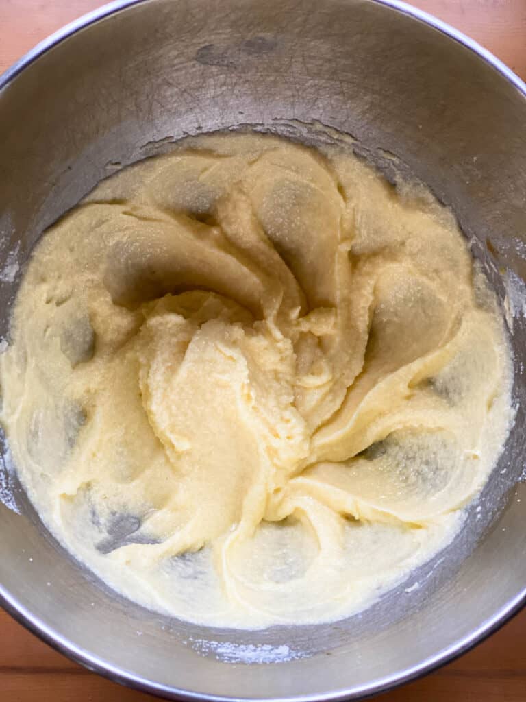 Butter, sugar and eggs combined in stand mixer bowl.