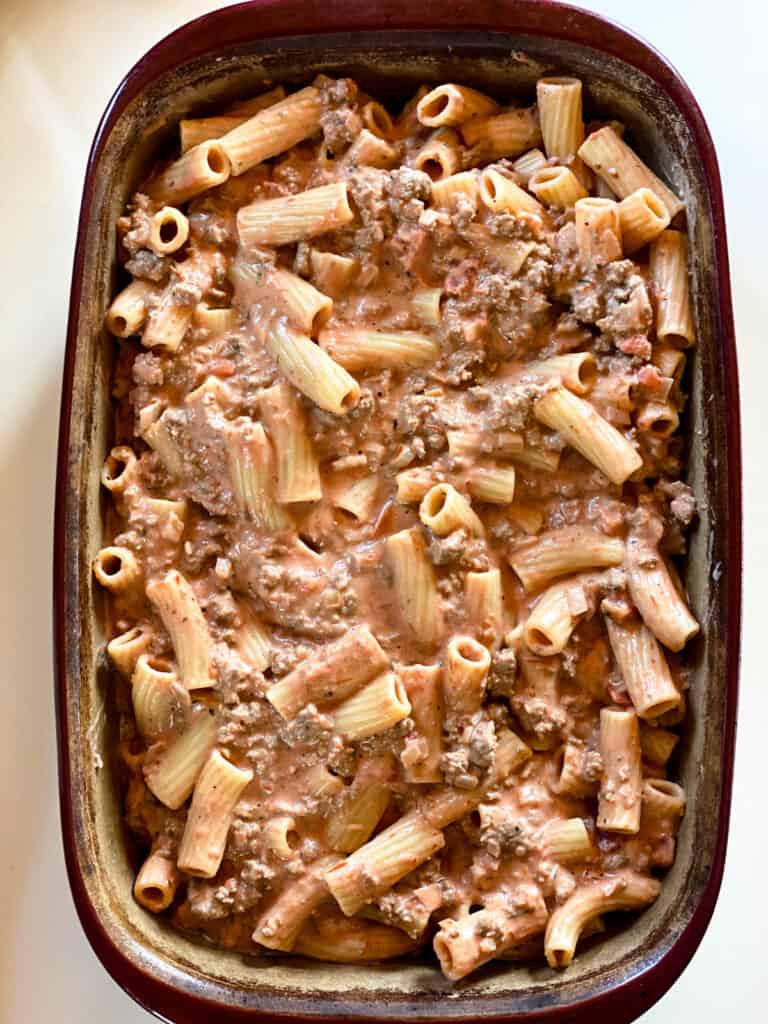 Combined pasta and meat sauce added to casserole dish.