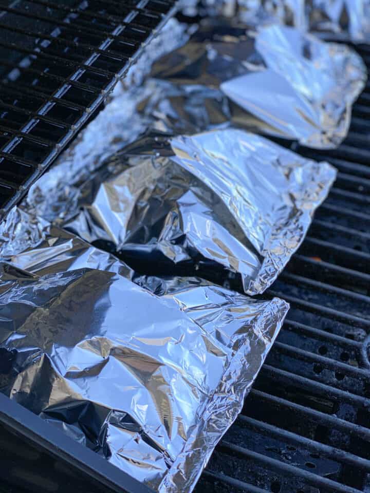 Completed foil packets on the grill.