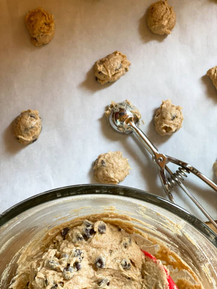 Cookie dough on scooped on cookie sheet.