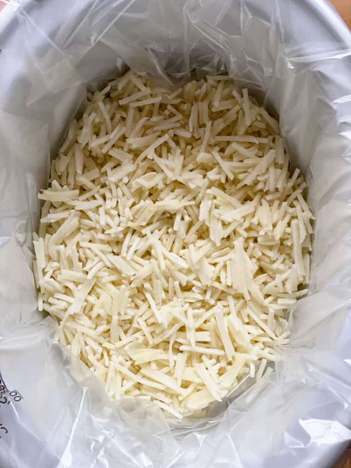 Hash browns added to bottom of crock pot.