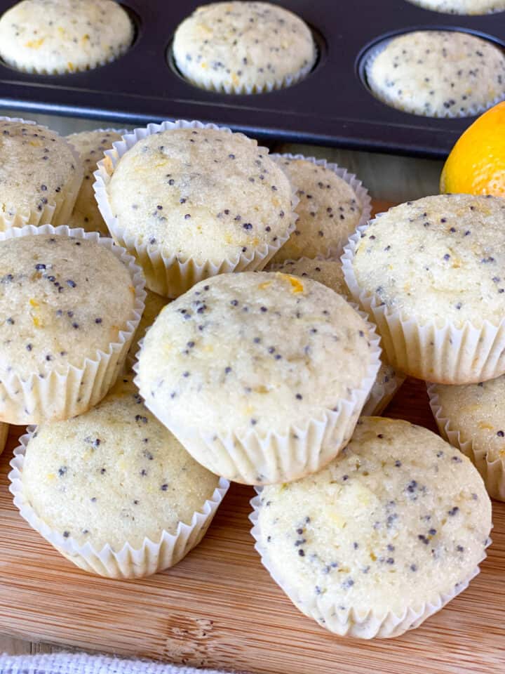 Top view of meyer lemon poppy seed muffins in pile on board.