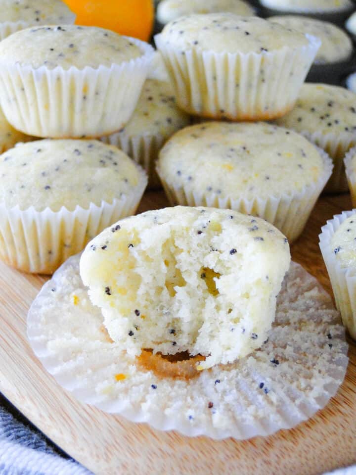 Close up view of meyer lemon poppy seed muffin with bite taken out.