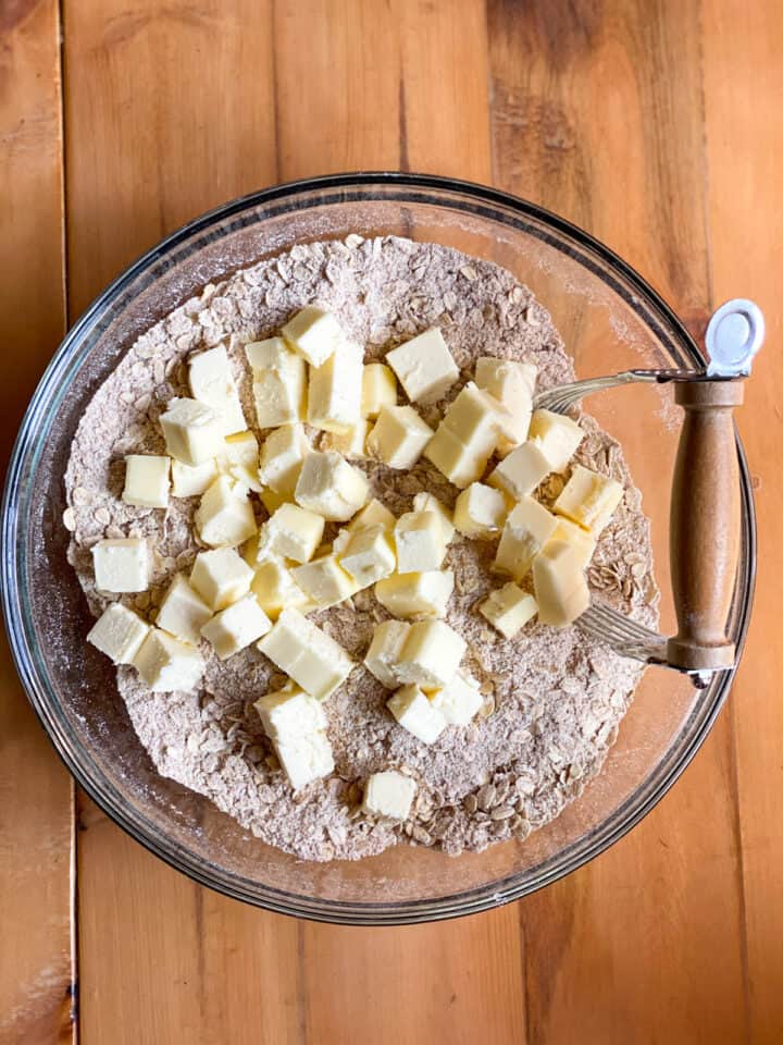 Cubed butter added to oatmeal crust dry ingredients.