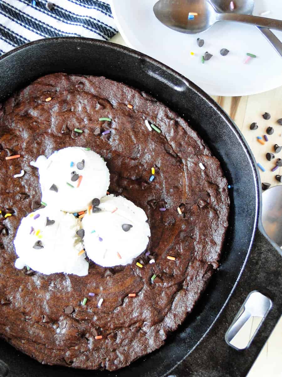 Top view of Mexican Brownie Skillet topped with three scoops of ice cream and multi colored sprinkles.