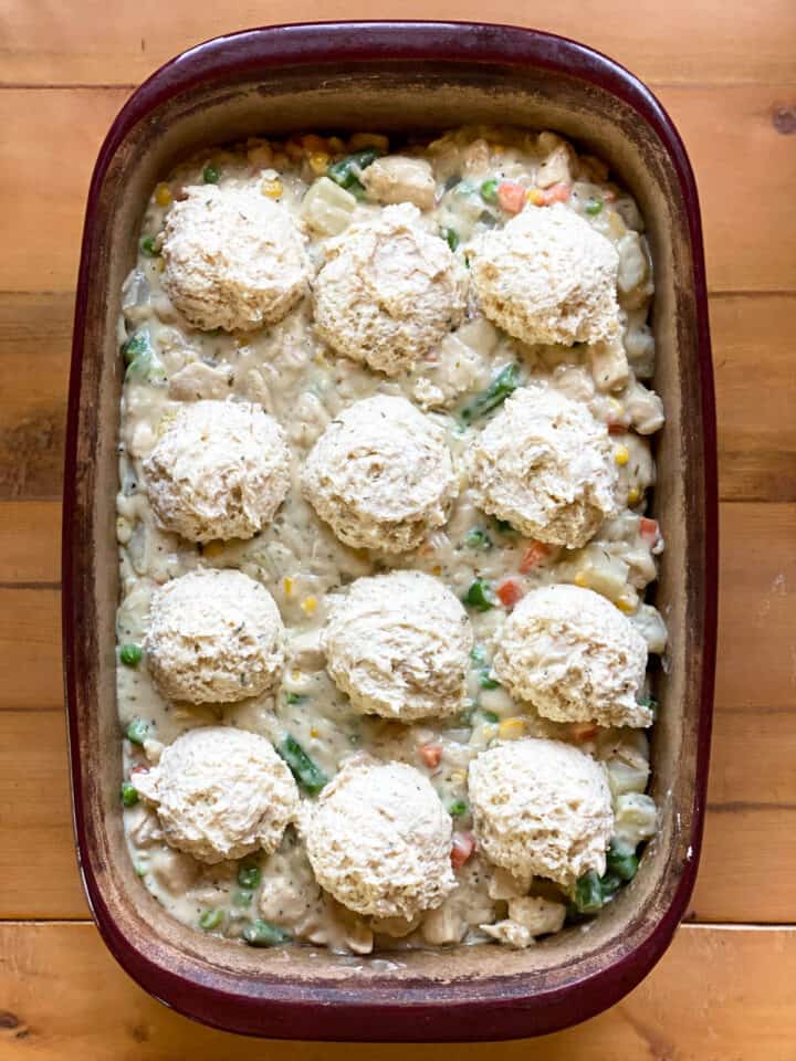 Fully assembled easy chicken pot pie with biscuits in deep rectangle casserole dish.