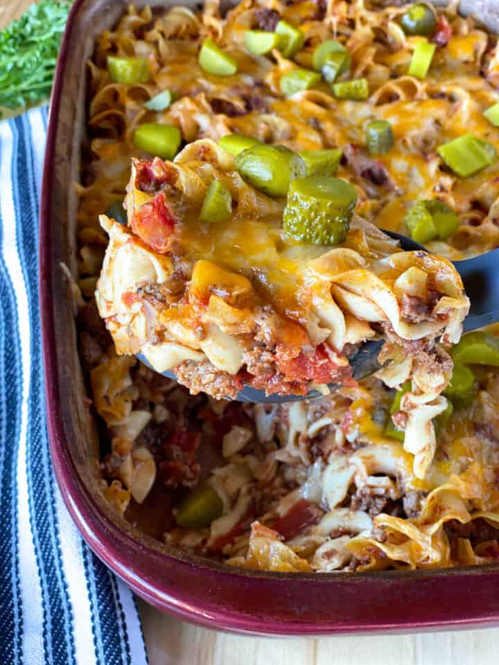 Easy cheeseburger casserole being scooped out of casserole dish.