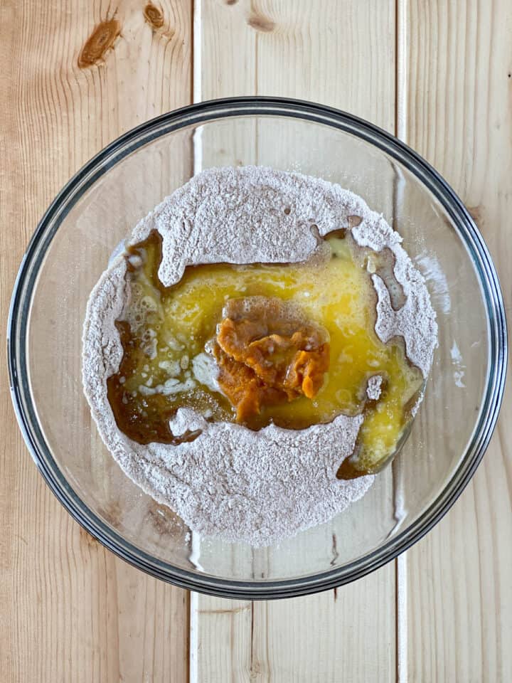 Wet ingredients added to dry in large glass mixing bowl.