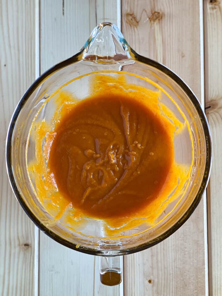 Wet ingredients mixed in a glass batter bowl.