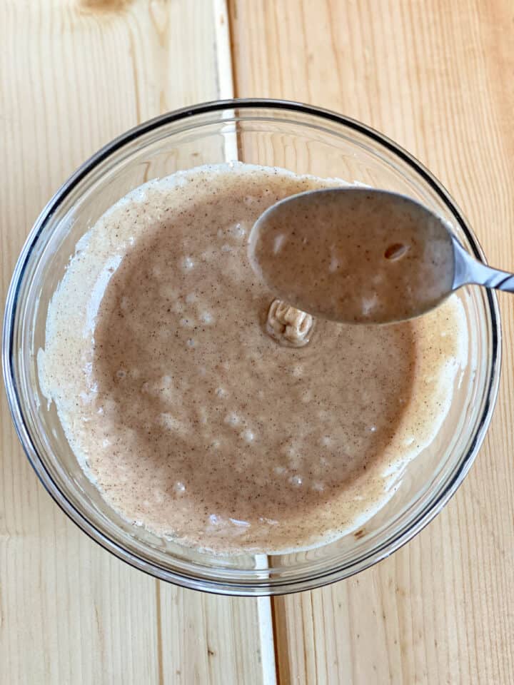 Frosting turned to glaze drizzling off of a spoon.