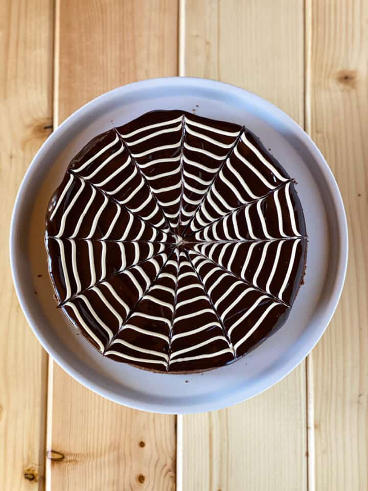 Buttercream and chocolate ganache created to make a spiderweb on top of brownie base.