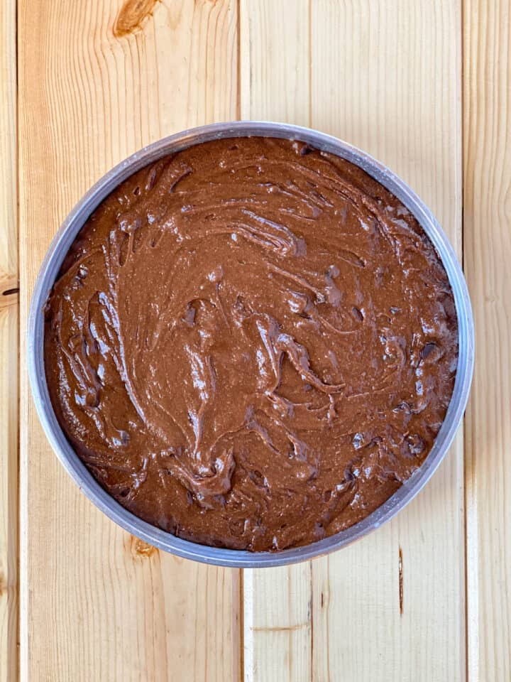 Brownie batter in round baking pan.