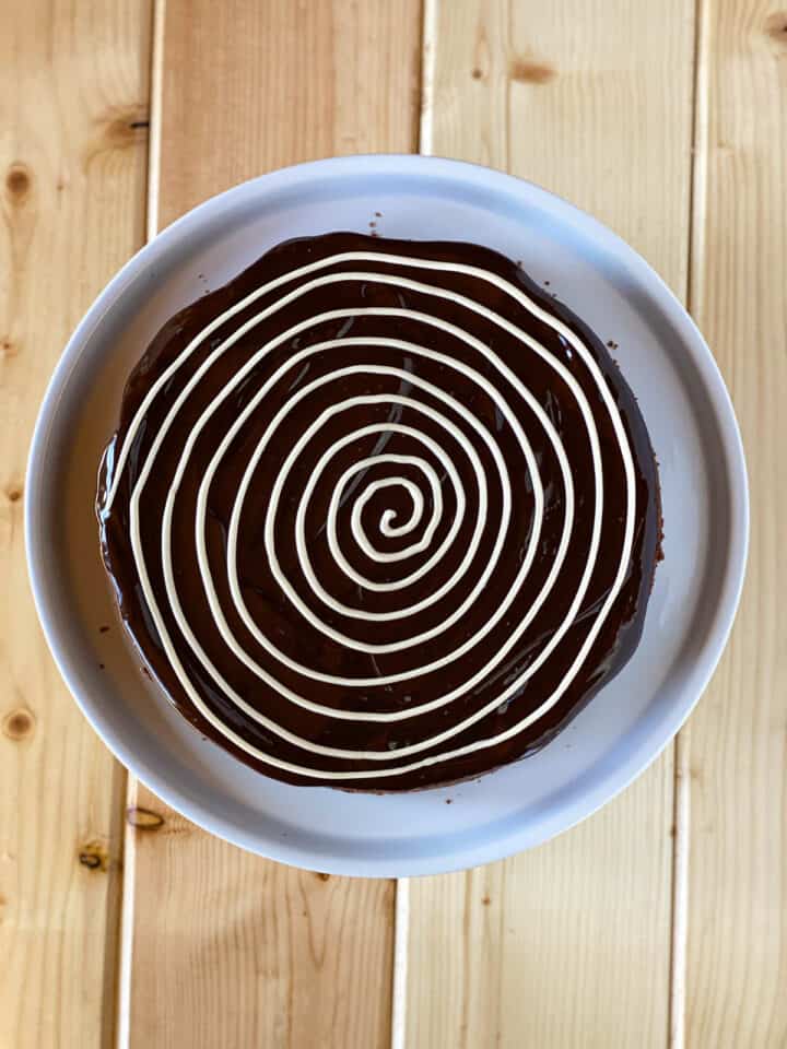 Buttercream piped in a spiral direction on top of the chocolate ganache.