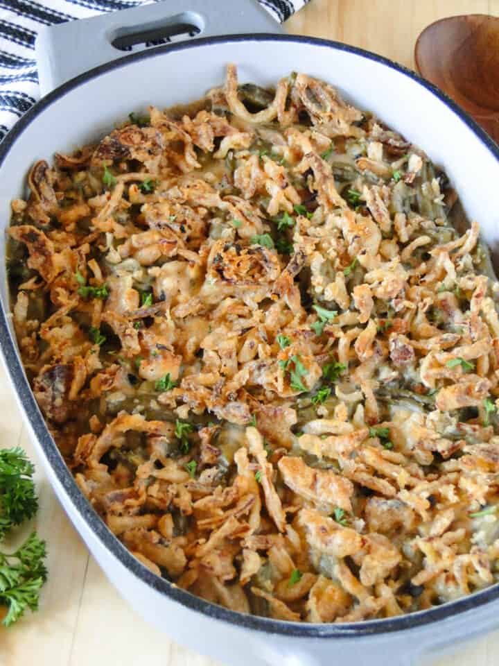Side view of homemade green bean casserole in oval casserole dish.