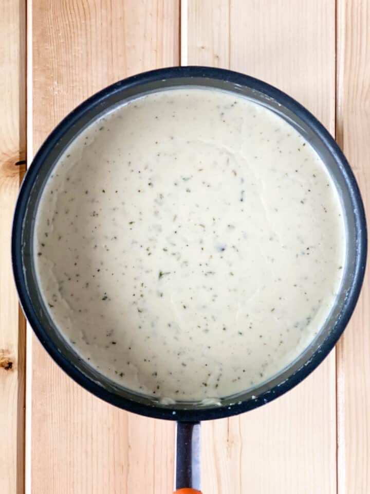 Completed white sauce in round sauce pan.